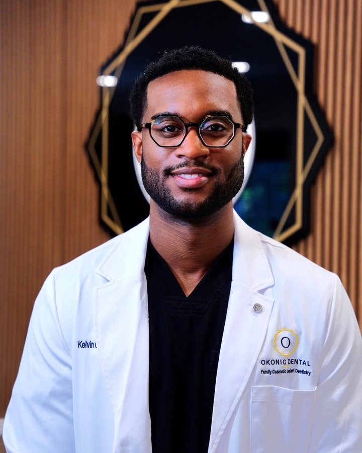 Dr. Kelvin Okons, DDS, in an Okonic Dental white coat at the practice